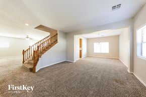 Surprise house for rent - an empty living room with a staircase in a house