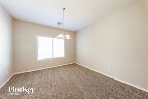 Surprise house for rent - a spacious living room with carpet and a window