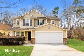 Atlanta house for rent - a yellow house with a white garage door