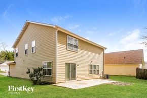Atlanta house for rent - the outside of a yellow house with a yard and grass