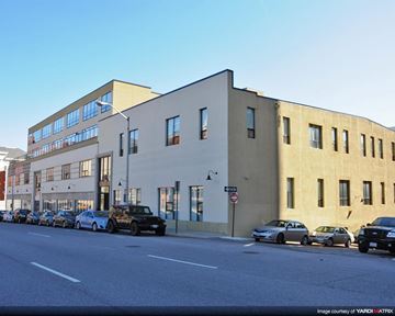 Baltimore apartment for rent - a large building with cars parked on the street