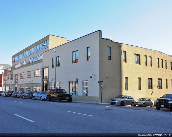 Baltimore apartment for rent - a large building with cars parked on the street