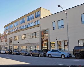 Baltimore apartment for rent - a large building with cars parked in front of it