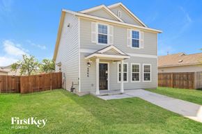 San Antonio house for rent - a white house with a yard and a wooden fence