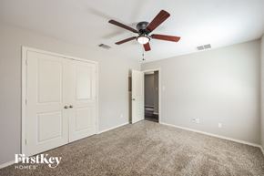 San Antonio house for rent - a bedroom with a ceiling fan and a door to a closet