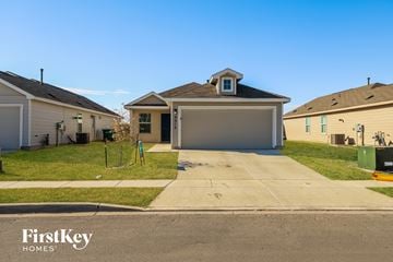 Converse house for rent - a home in a neighborhood with a driveway and a garage door