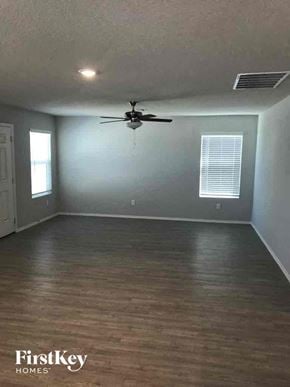 Converse house for rent - an empty living room with a ceiling fan