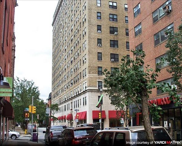 Philadelphia apartment for rent - a busy city street with cars and a tall building