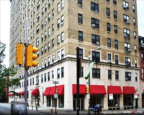Philadelphia apartment for rent - a traffic light in front of a tall building