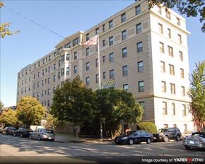 Richmond apartment for rent - a large building with cars parked in front of it