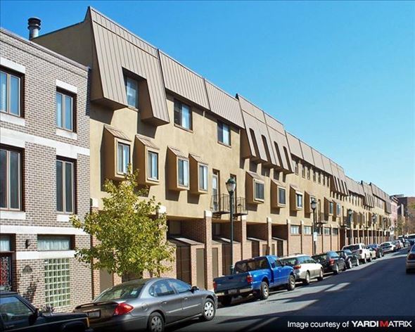 Philadelphia apartment for rent - a row of buildings with cars parked on the street