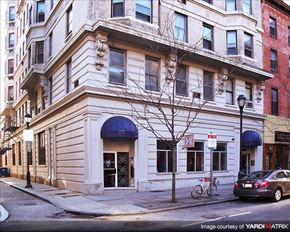 Philadelphia apartment for rent - a white building on the corner of a street with a car
