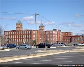 Columbia apartment for rent - a large brick building with cars parked in a parking lot