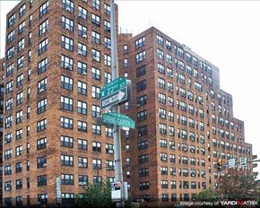 Philadelphia apartment for rent - a tall building with street signs in front of it