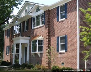 Baltimore apartment for rent - a red brick house with black shuttered windows