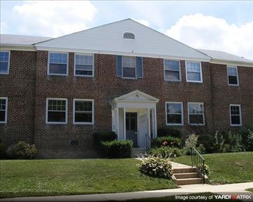Baltimore apartment for rent - a brick building with a lawn in front of it