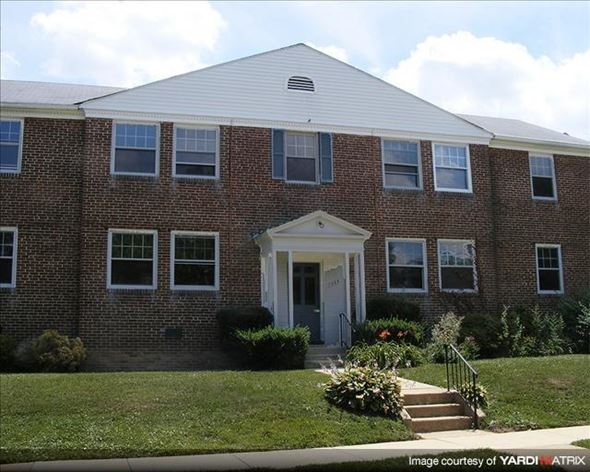 Baltimore apartment for rent - a brick building with a lawn in front of it