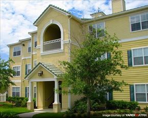 Wesley Chapel apartment for rent - a yellow house with a tree in front of it