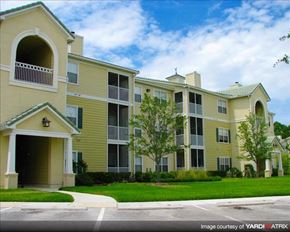 Wesley Chapel apartment for rent - an apartment building with a green lawn and trees