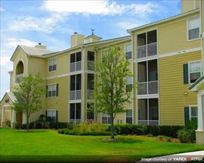 Wesley Chapel apartment for rent - an apartment building with a green lawn and trees