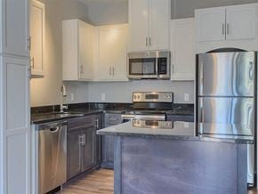 Millbury apartment for rent - a kitchen with stainless steel appliances and white cabinets