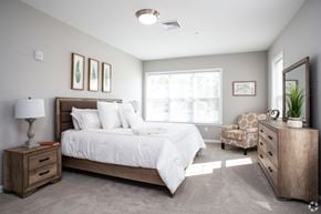 Millbury apartment for rent - a bedroom with a bed and a dresser and a window