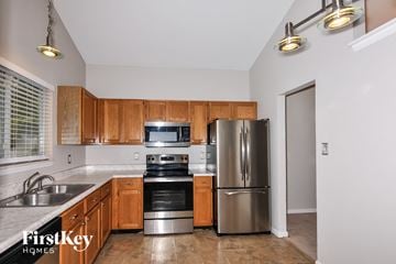 Saint Charles house for rent - A kitchen with wooden cabinets and stainless steel appliances.