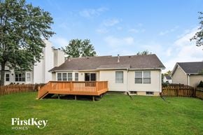 Saint Charles house for rent - A house with a white exterior and a brown deck in the foreground.