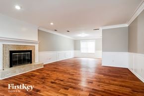 Lilburn house for rent - a living room with a fireplace and wooden floors