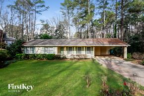 Lilburn house for rent - a small house with a lawn and a driveway