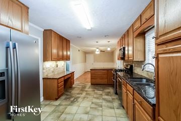 Lilburn house for rent - a kitchen with wooden cabinets and a stainless steel refrigerator
