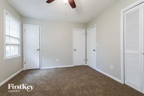 Lilburn house for rent - a bedroom with a carpeted floor and white doors