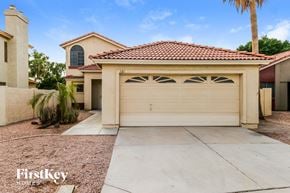 Gilbert house for rent - a home with a white garage door and a driveway