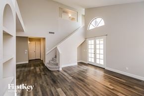 Gilbert house for rent - an empty living room with hardwood floors and a staircase