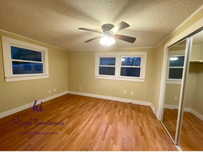 Slater-Marietta house for rent - A room with a ceiling fan and wooden flooring.