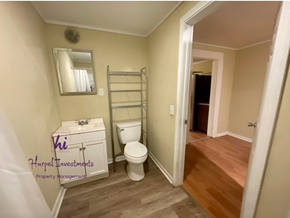Slater-Marietta house for rent - A bathroom with a toilet, sink, and a mirror.
