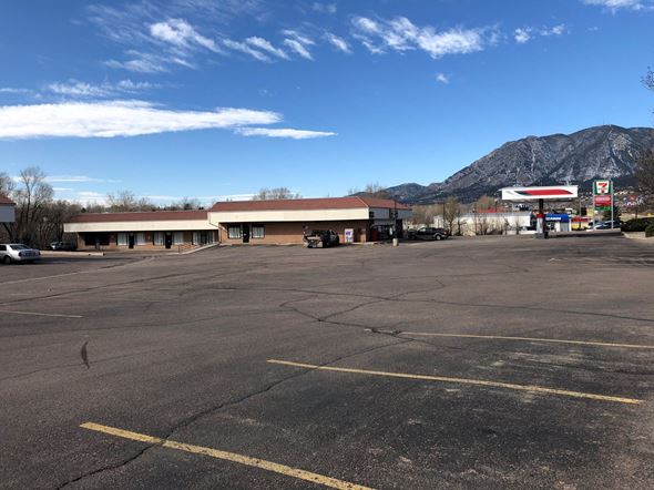 Colorado Springs apartment for rent - a gas station in a empty parking lot with a mountain in the background