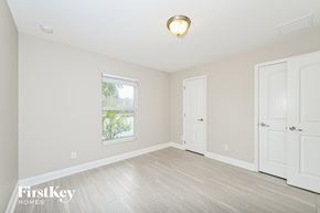 Apopka house for rent - a bedroom with white walls and white doors and a window