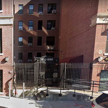 Bronx apartment for rent - the front of a brick building with a gate