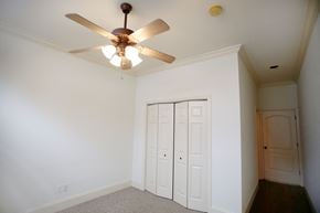 New Orleans apartment for rent - a bedroom with a ceiling fan and two closet doors