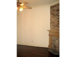 New Orleans apartment for rent - a living room with a fireplace and a ceiling fan