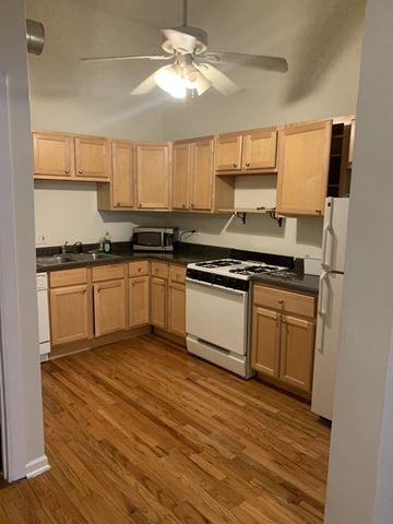 Chicago apartment for rent - an empty kitchen with wooden floors and wooden cabinets
