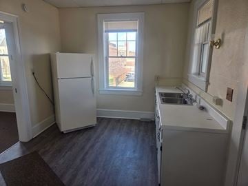 Canton apartment for rent - A kitchen with a white fridge and a window.