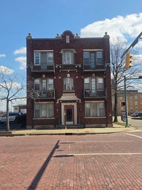 Canton apartment for rent - A red brick building with a balcony on the second floor.