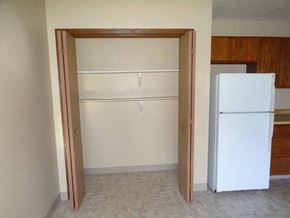 Williston apartment for rent - an empty kitchen with a white refrigerator and an open door