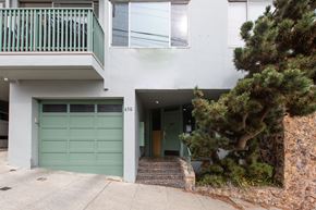 San Francisco apartment for rent - A white building with a green garage door.