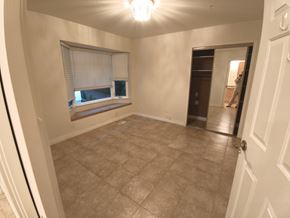 Belcarra apartment for rent - A room with a tiled floor and a window with blinds.