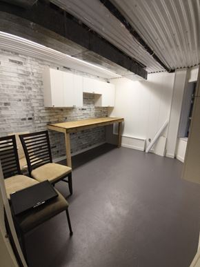 Belcarra apartment for rent - A room with a brick wall and a wooden table.