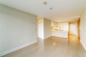 Coquitlam apartment for rent - an empty living room and kitchen with wood floors