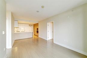 Coquitlam apartment for rent - an empty living room and kitchen with wood floors